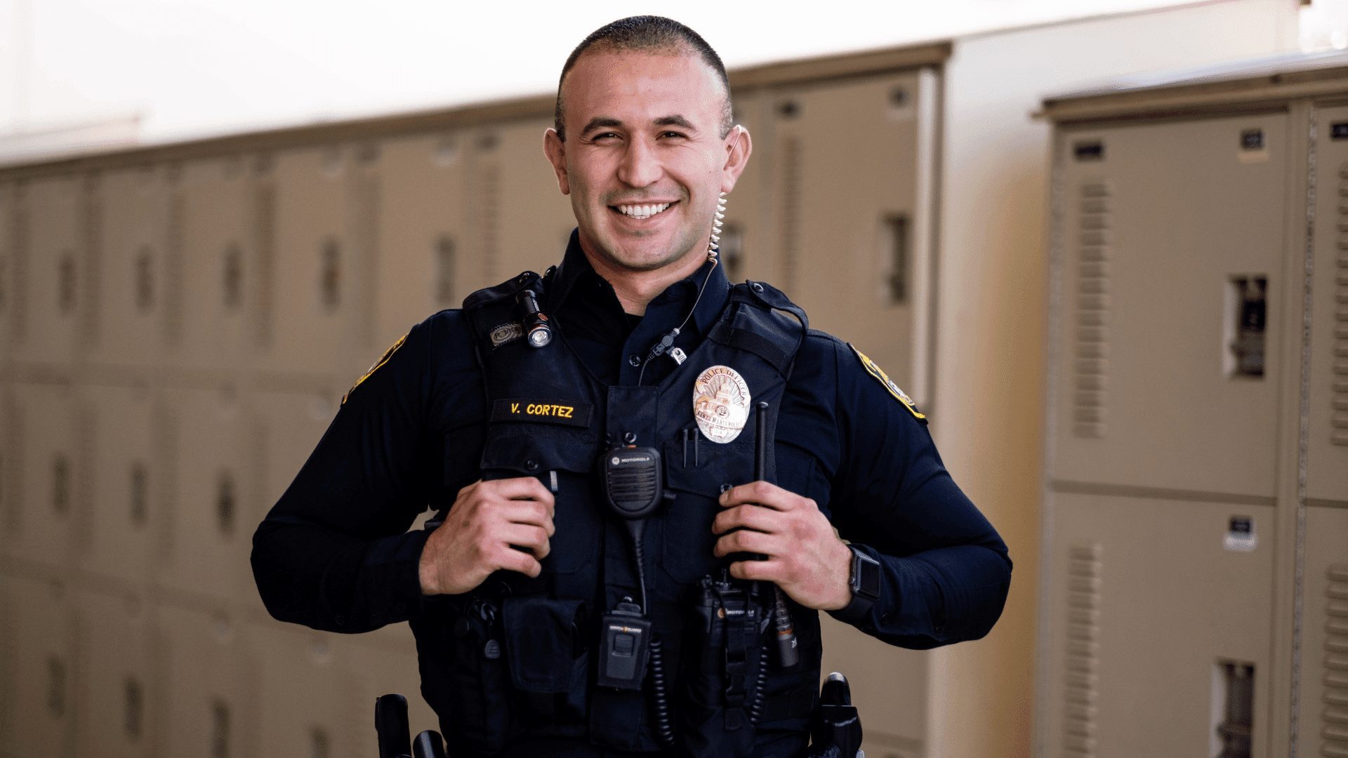 Santa Maria Police Officer Victor Cortez poses for a photo in front of the station's equipment lockers