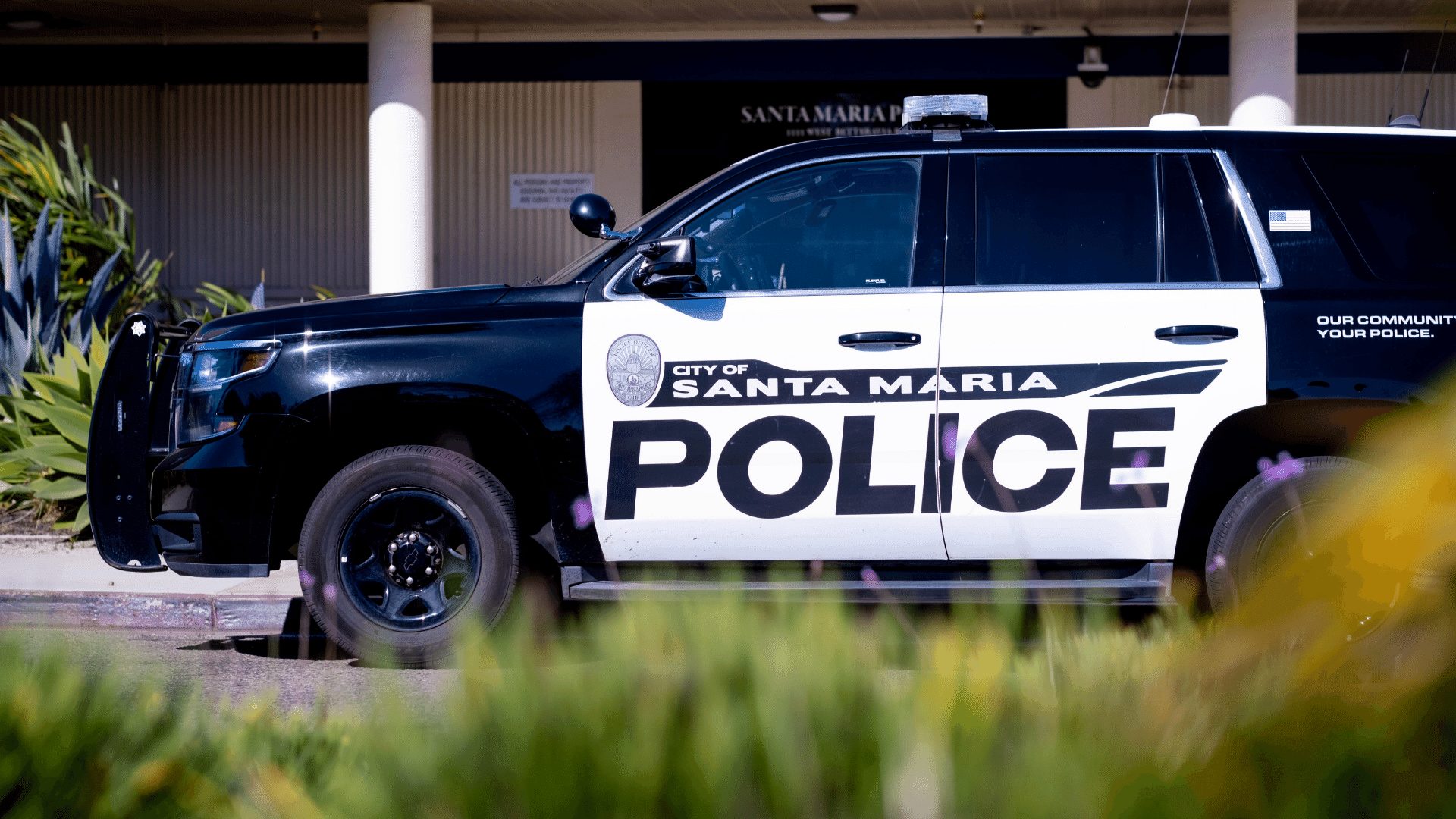A black and white Santa Maria Police SUV parked in front of Santa Maria Police Department