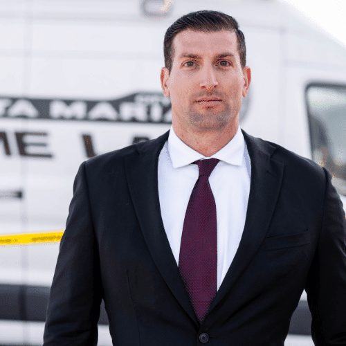 Santa Maria Police Detective Brian Santiago poses for a photo in front of the Santa Maria Police Crime Lab van